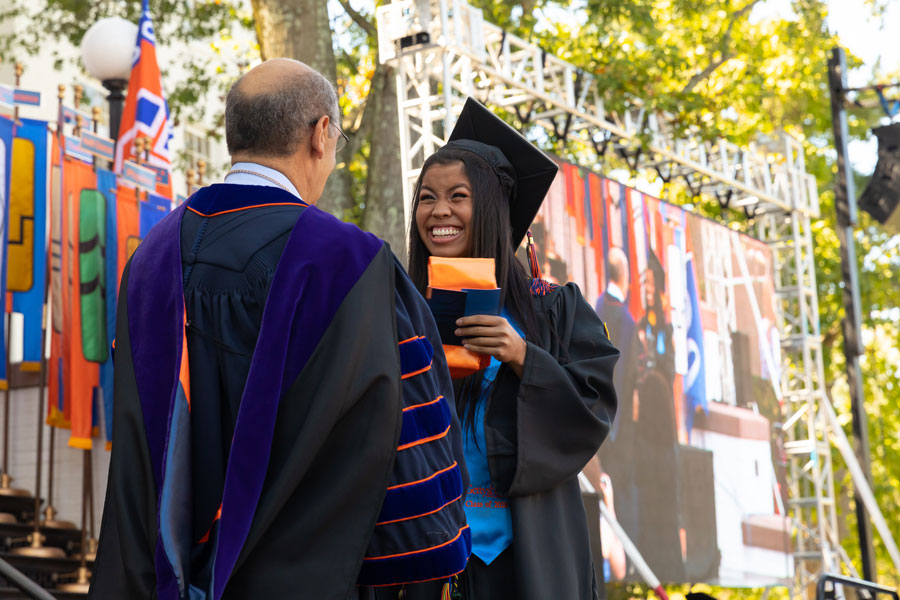 Bob Iuliano with a graduate receiving her diploma