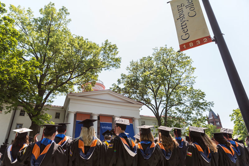 Graduates at Commencement facing Beachem Portico