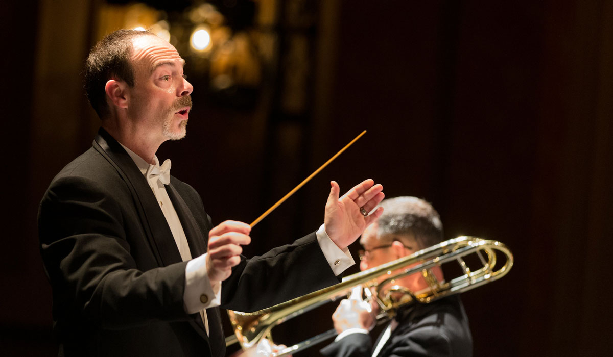 Russell McCutcheon conducting in a tuxedo