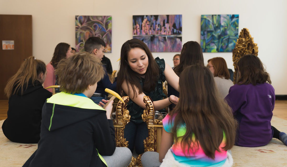 Teacher educating children about musical instruments at Sunderman Conservatory