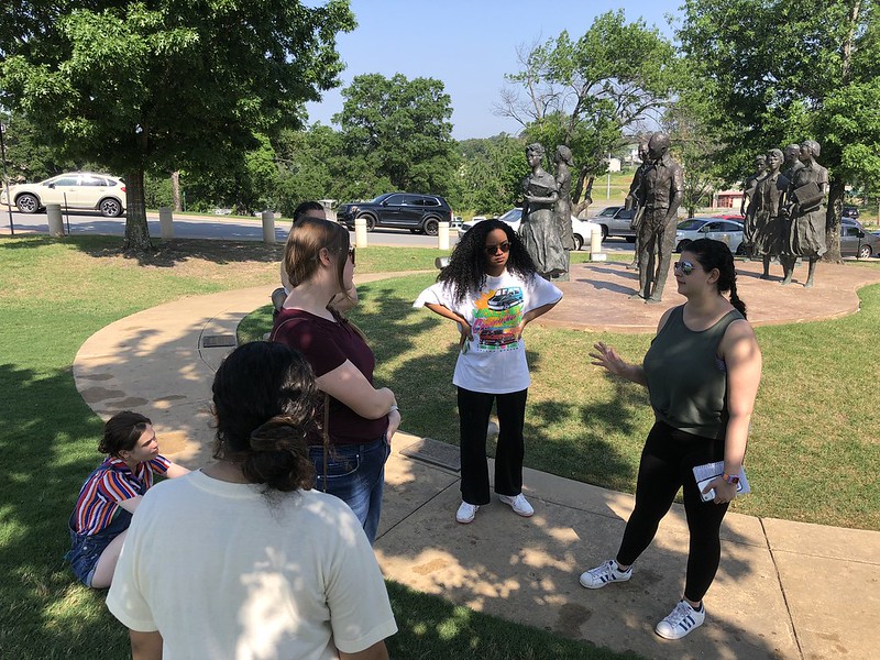 Photo of students discussing civil rights in front of the Little Rock Nine monument at the Arkansas statehouse