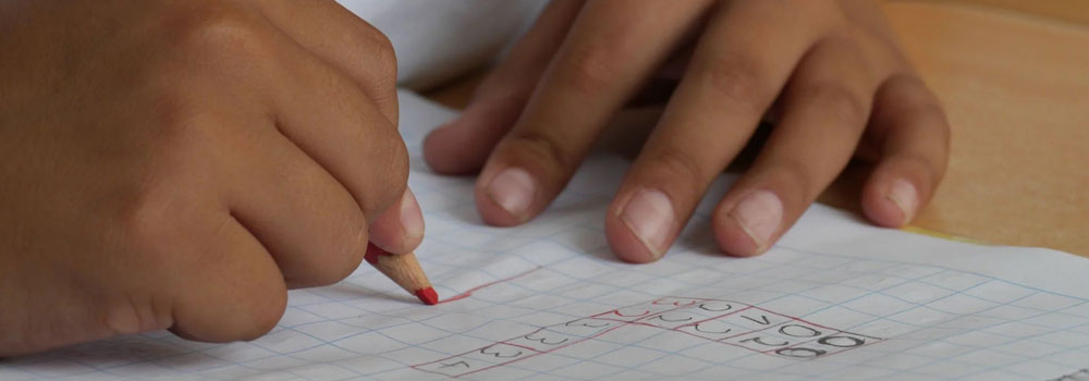 Hands of a school age child doing homework