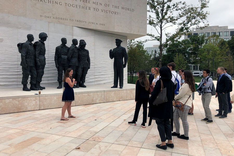 Photo of woman talking about an outdoor statue of Dwight Eisenhower