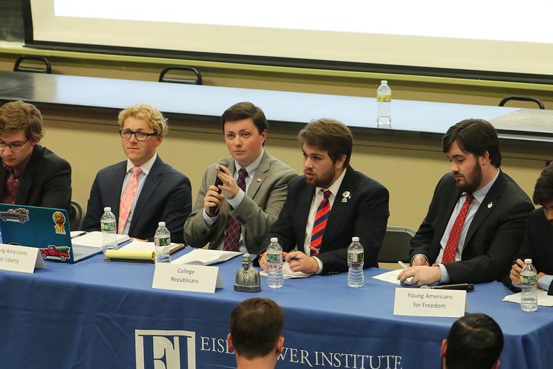 Students sitting at a table having a debate