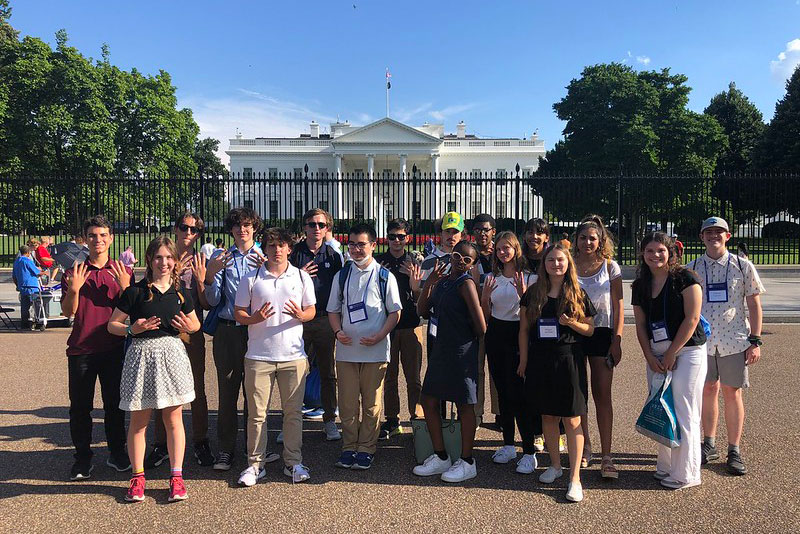 Students standing for a picture in front of the White House