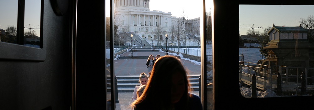 Women getting off a bus in front of the Capitol building
