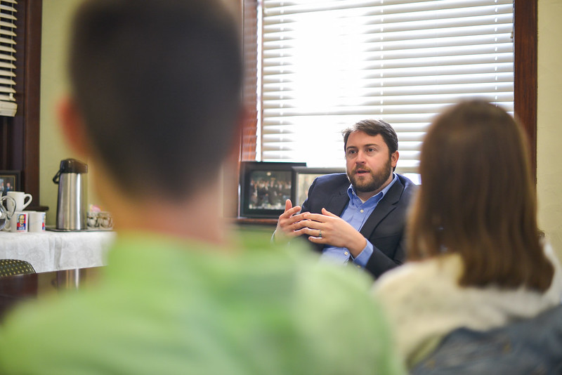 Photo of an audience watching a man give a lecture