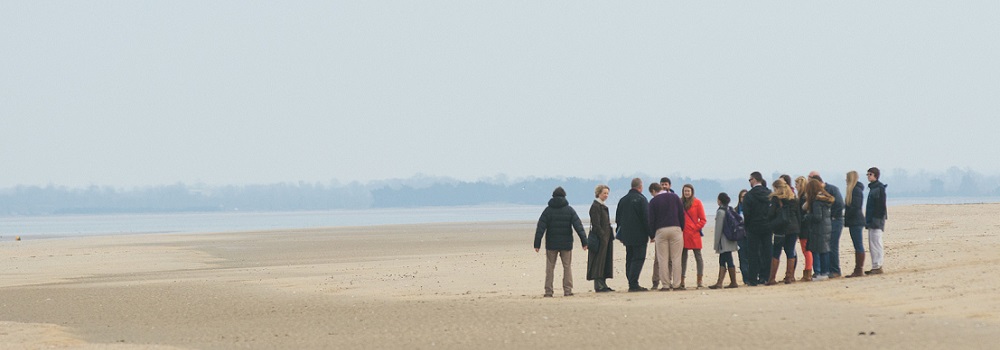 Crowd of people standing on the beach