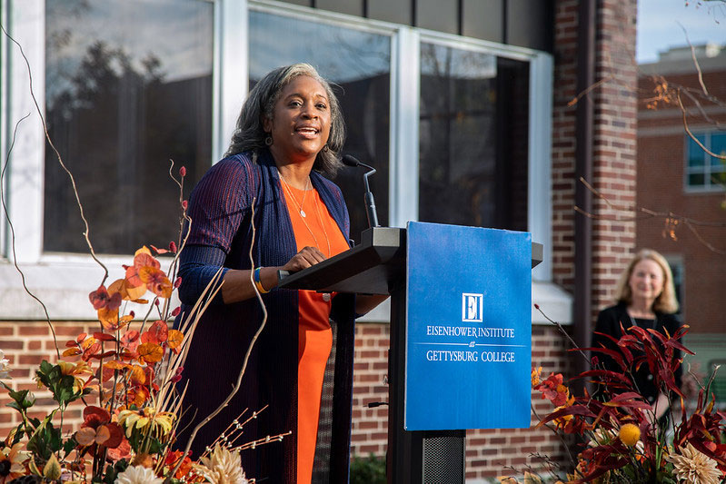 Tracie Potts speaking from a podium outside