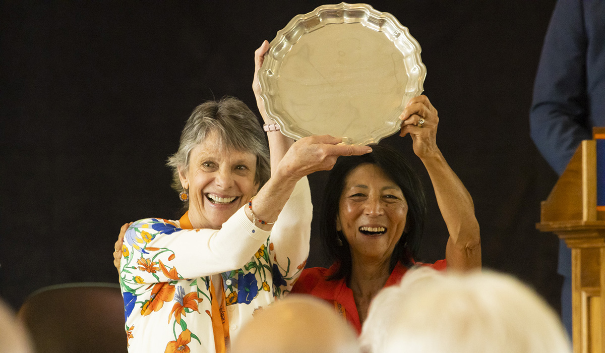 Class of 1973 reunion co-chairs Jean LeGros ’73 and Lori Kono Clapp ’73 hold up the Verna A. Schwartz ’13 Reunion Fund Trophy