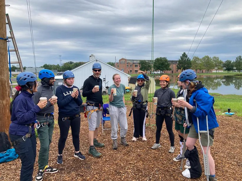 A team celebrates a successful adventure with drinks, camaraderie, and smiles