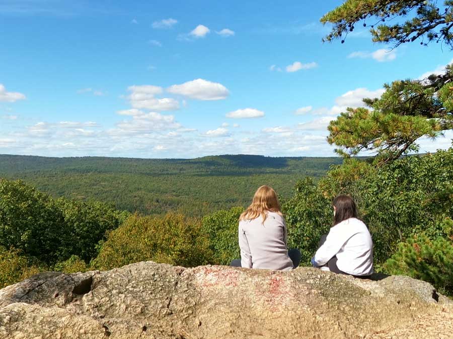 Students sitting on rocks outdoors