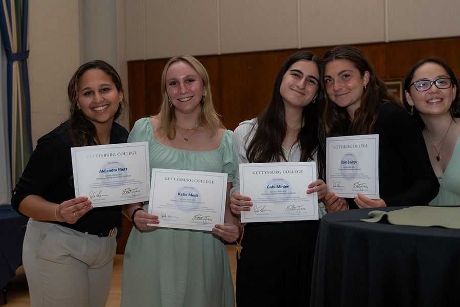 A group of students holding their certificates