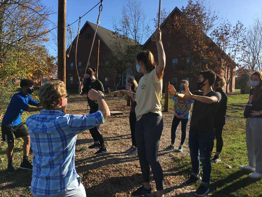 Students training with a low hanging element