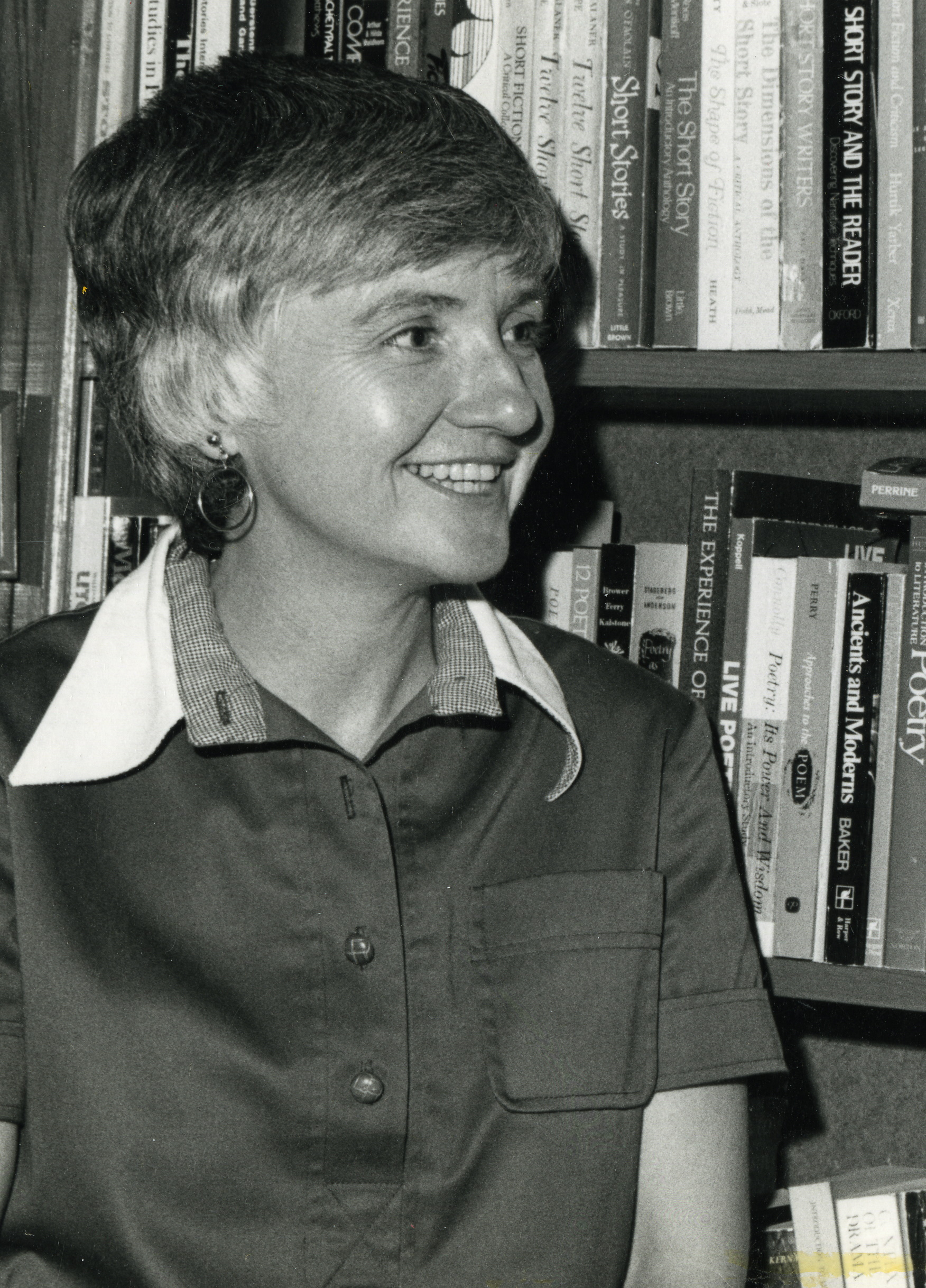 Photograph of Margaret Mary Stewart standing in front of a bookshelf