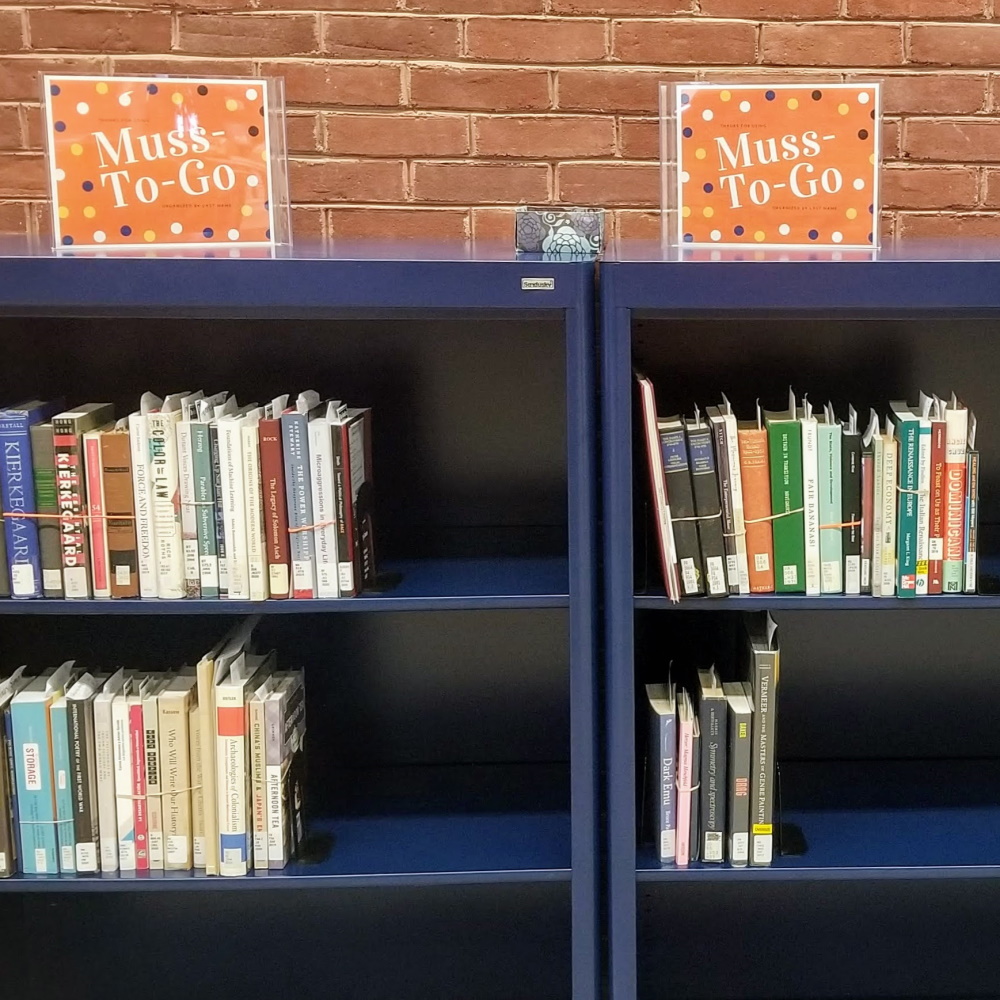Muss-To-Go shelves filled with books for pickup