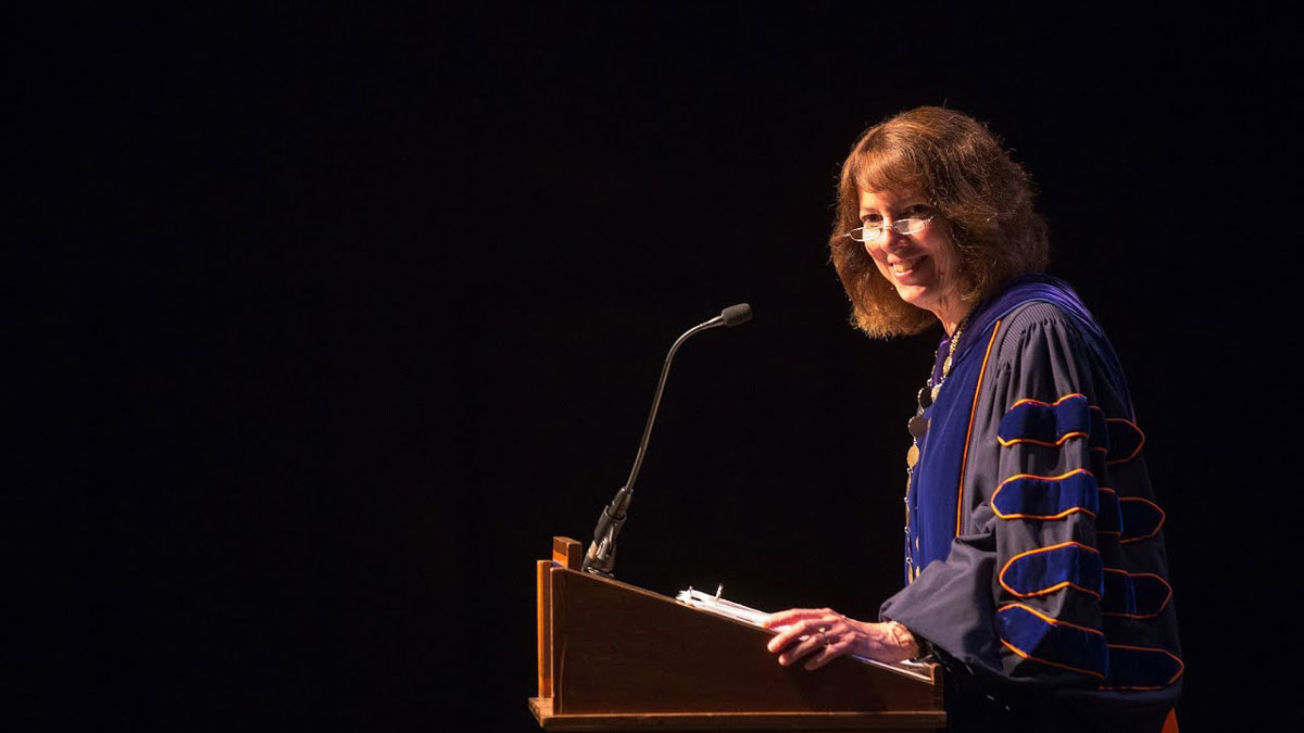 Janet Morgan Riggs ’77 smiling on stage