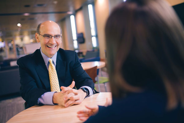 President Bob Iuliano smiling at a student