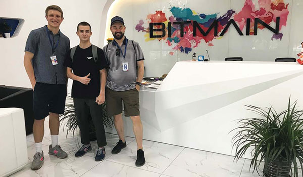Tyler Mann ’20, Corentin Mercier and Economics Professor Rimvydas Baltaduonis standing in front of Bitmain office