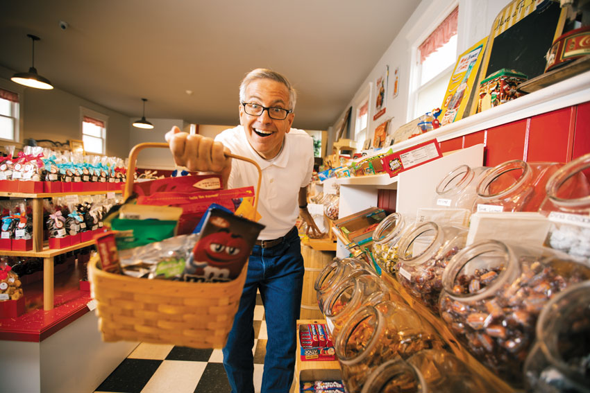 David Borghesani with a basket of candy in a candy store