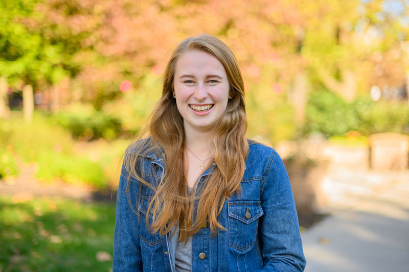 Caroline Cuetara standing on a campus walkway