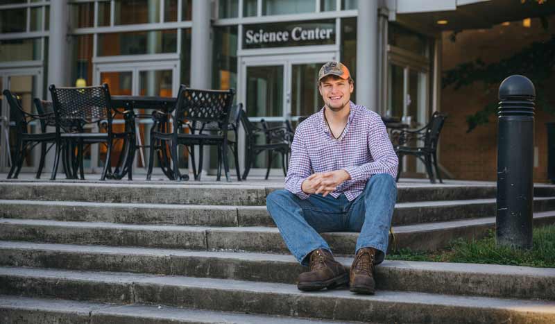 Cordell Boggs ’17 sitting in front of Science Center