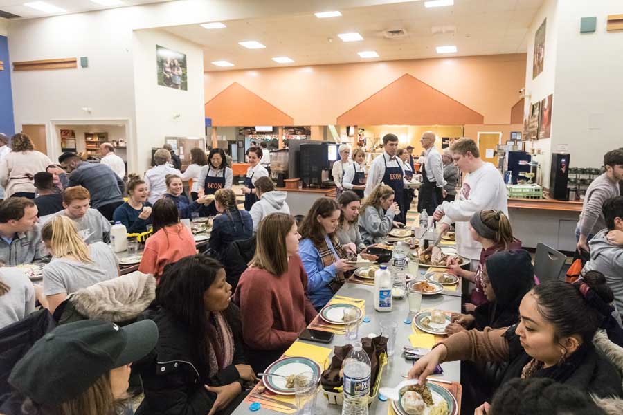 Economics department serving students thanksgiving dinner