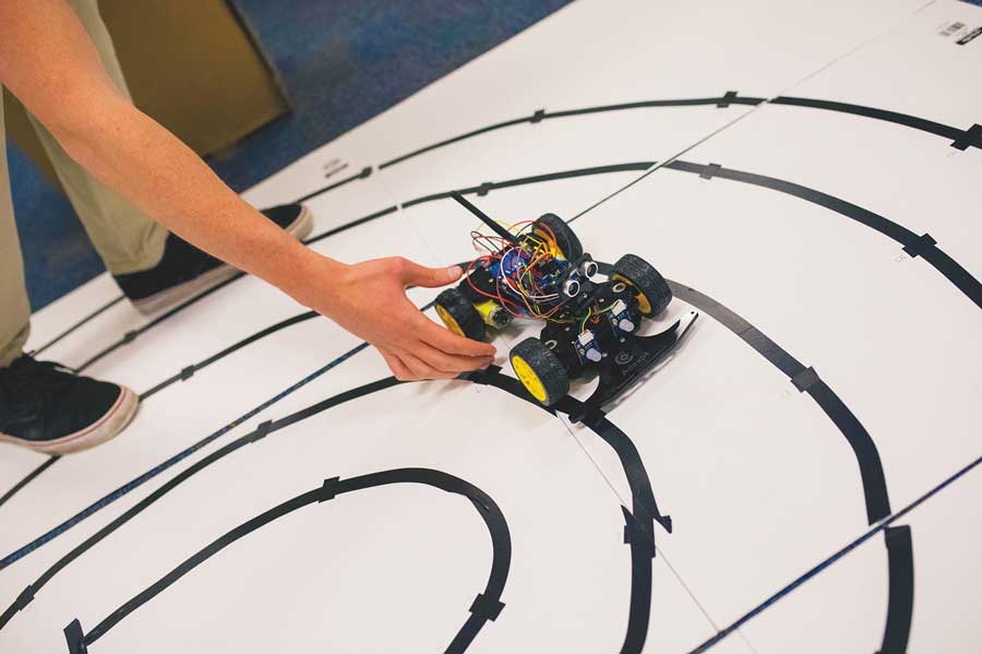 Person placing a remote control car on the floor