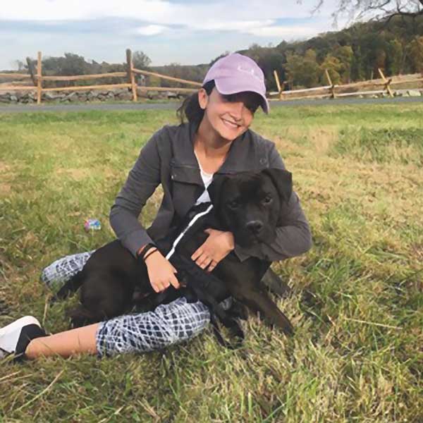 Anna Shah outside holding her dog Bubba