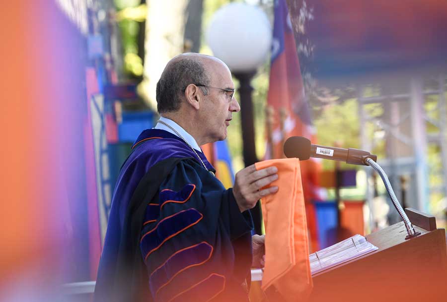 Bob Iuliano standing at the podium with an orange stole