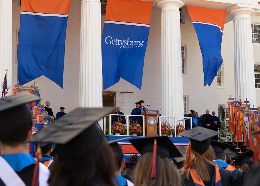 Speaker at a podium during Gettysburg Colleges commencement ceremony