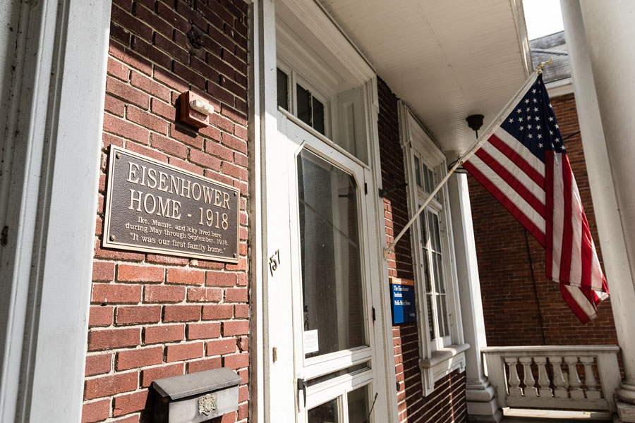 Front door of the eisenhower institute with am American flag hanging from the building