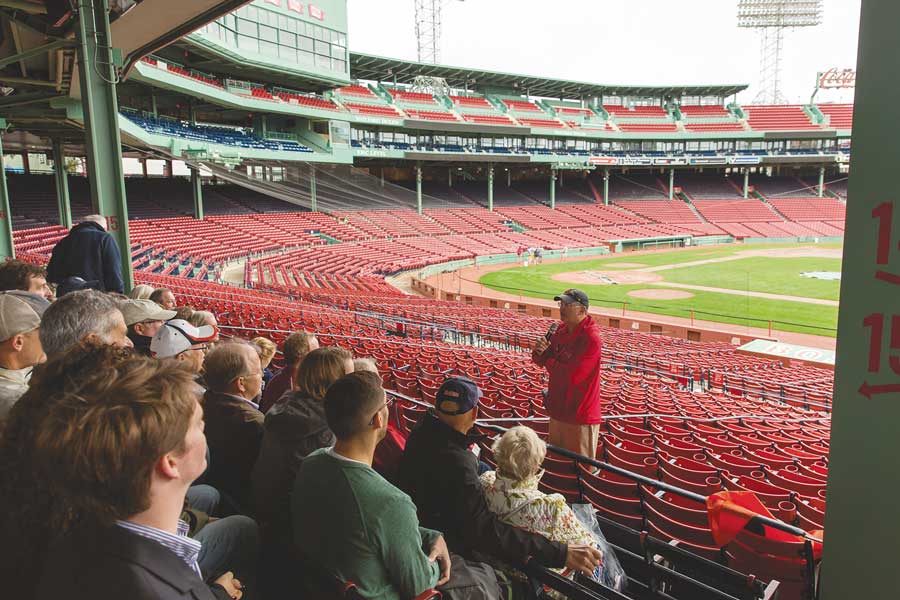 View from behind Gettysburg alumni sitting in the bleachers at a baseball game