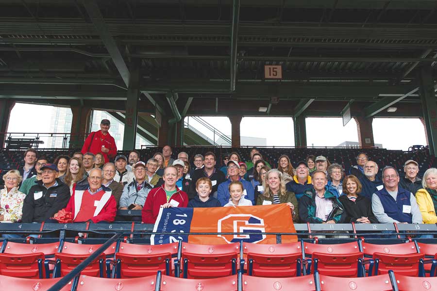 Gettysburg College alumni sitting in the bleachers at a baseball game