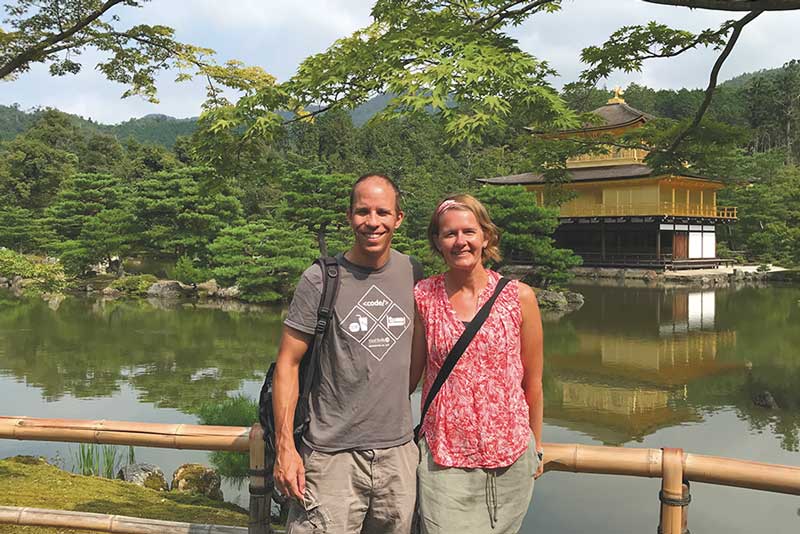 Shelli Frey standing in front of a Japanese temple with her husband