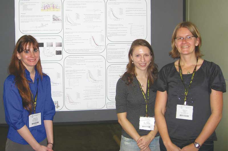 Shelli Frey with two students and a poster presenting their research