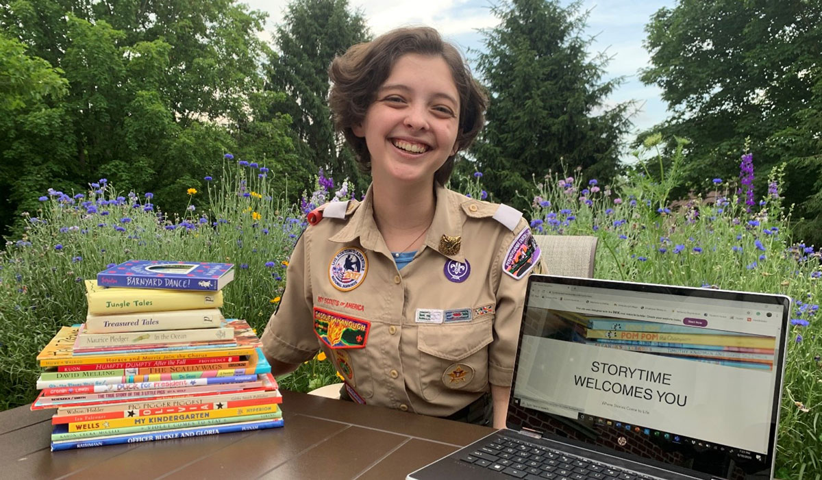 Lyndsey Nedrow in her Eagle Scout uniform with a laptop outdoors
