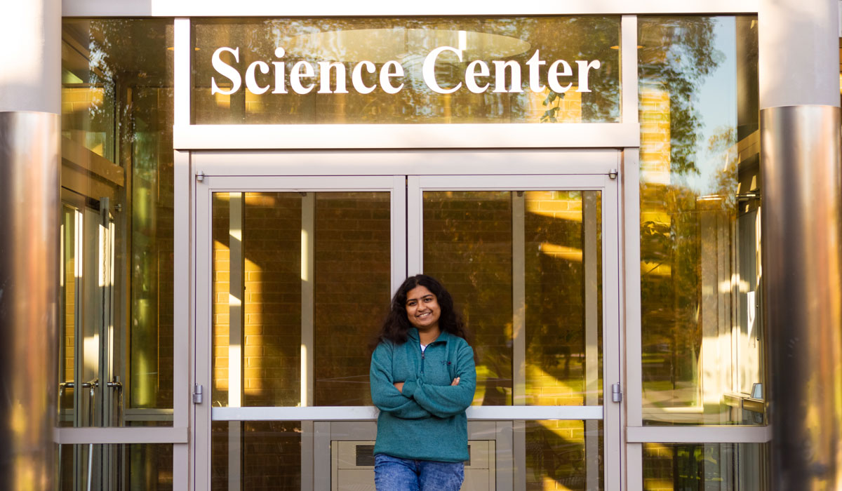 Meem Noshin Nawal Khan standing in front of the Science Center doors