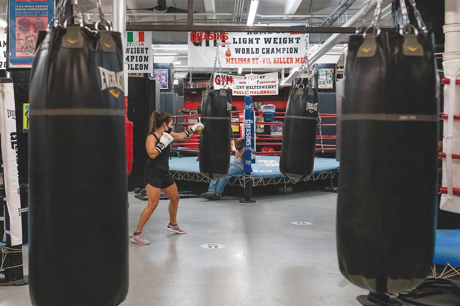 A woman punching at a punching bag