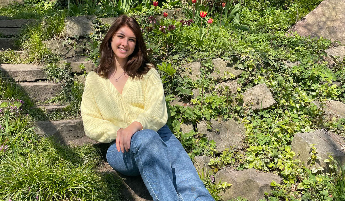 Aine Ford sitting on concrete steps