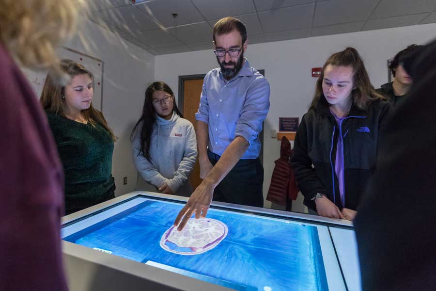 Health Sciences Prof. Josef Brandauer teaching students with an anatomage table