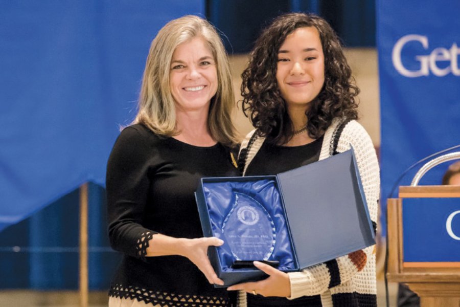 Miranda Zamora presenting Professor Anne Douds with an award