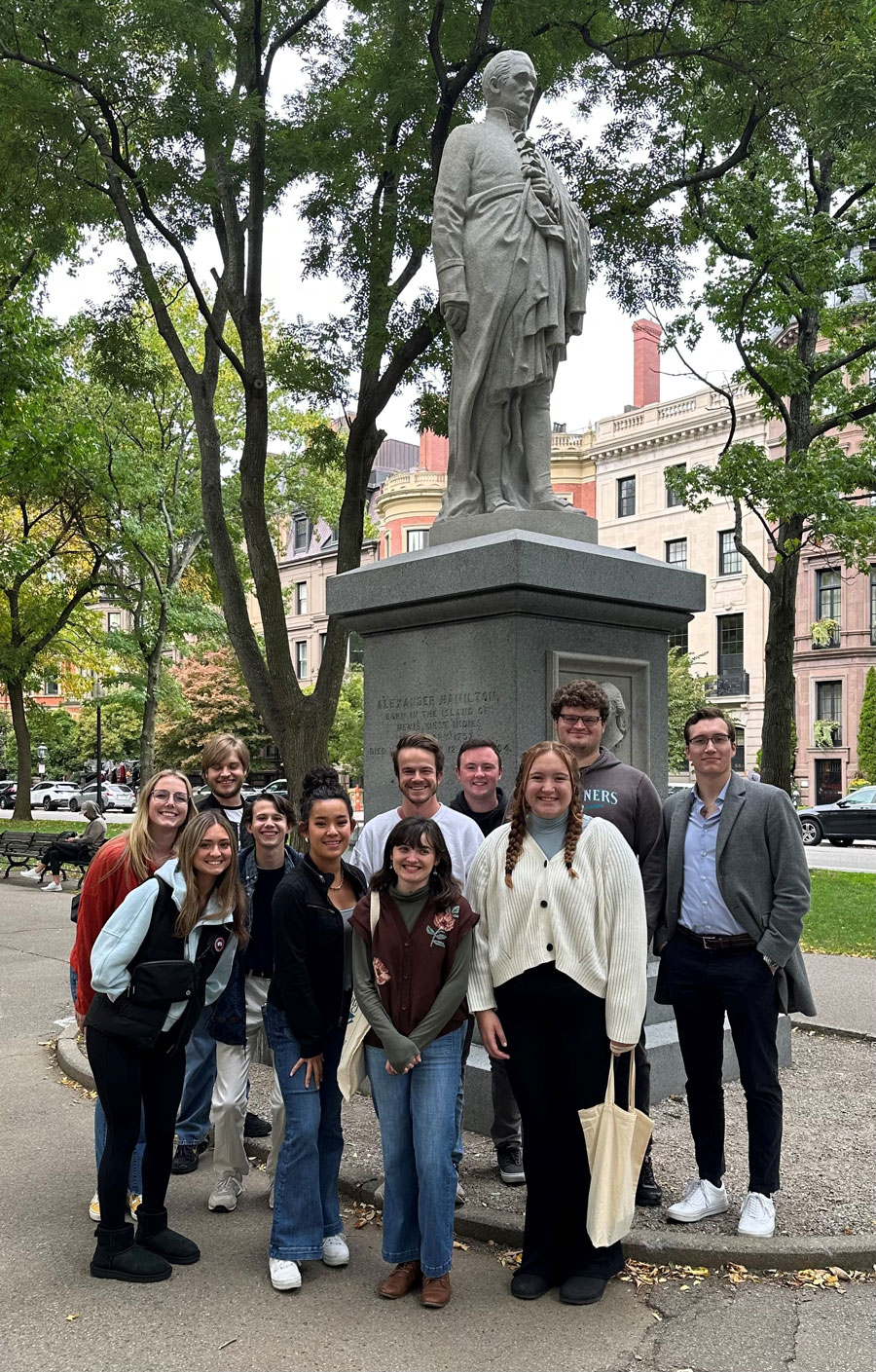 Political Science majors standing in front of a statue om Boston