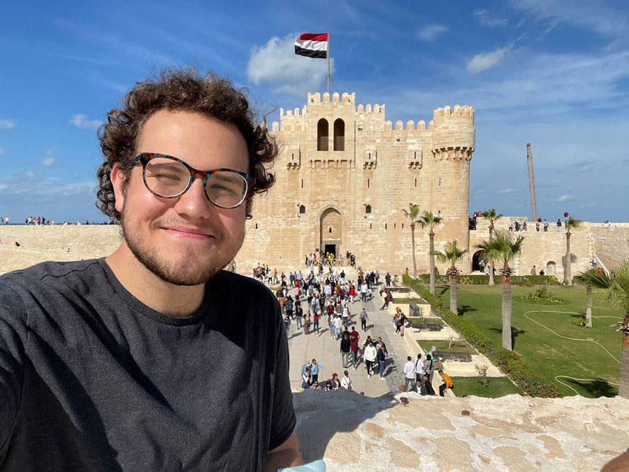 Brandon inside the courtyard of a stone Citadel in Egypt