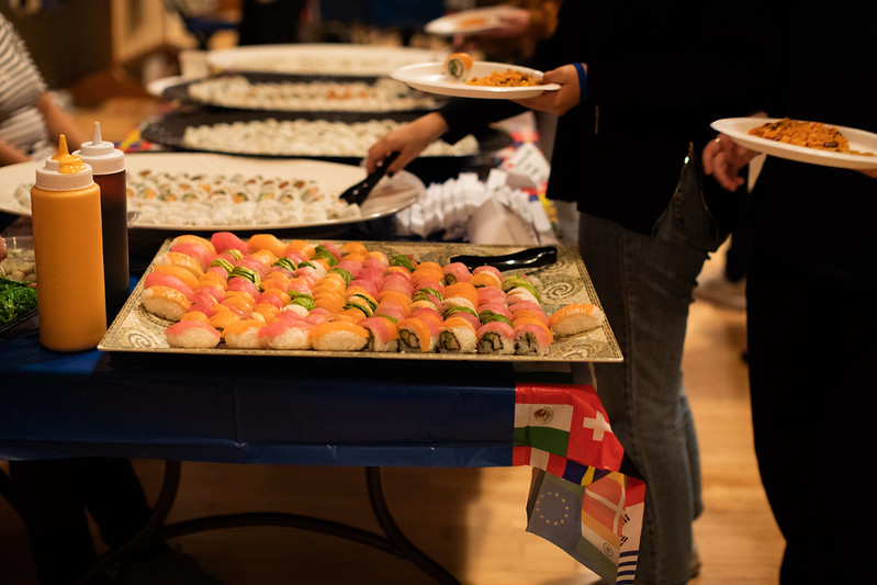 A table covered in large plates of sushi