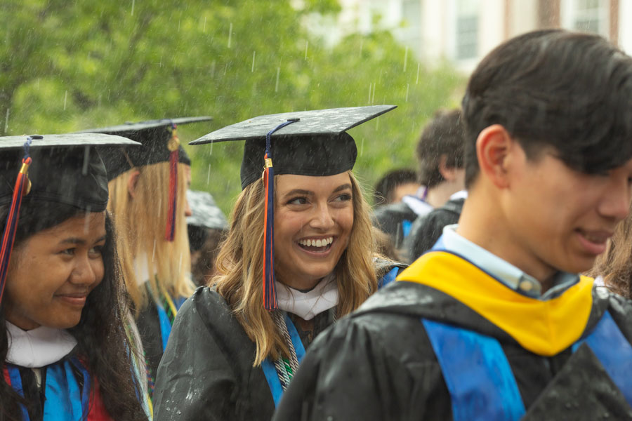 Graduates standing in the rain