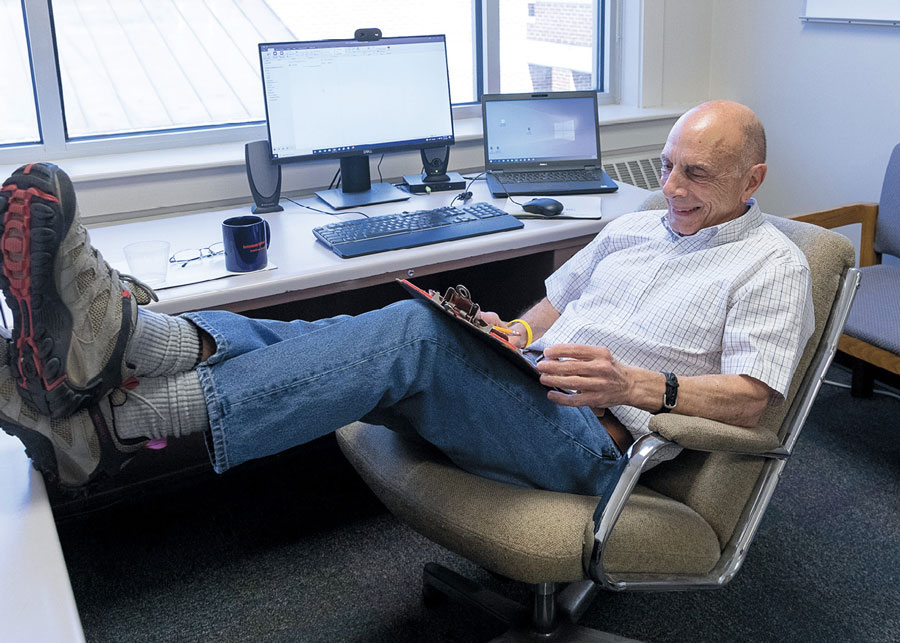 Prof. Bob D'Agostino laying back in his office chair