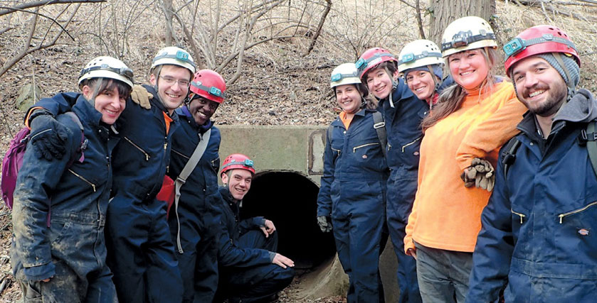 Douglas Page with other people outside a cave entrance