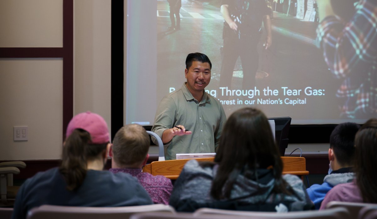 Eric speaking to a group of students