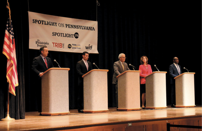 Spotlight on PA debate with speakers at their podiums